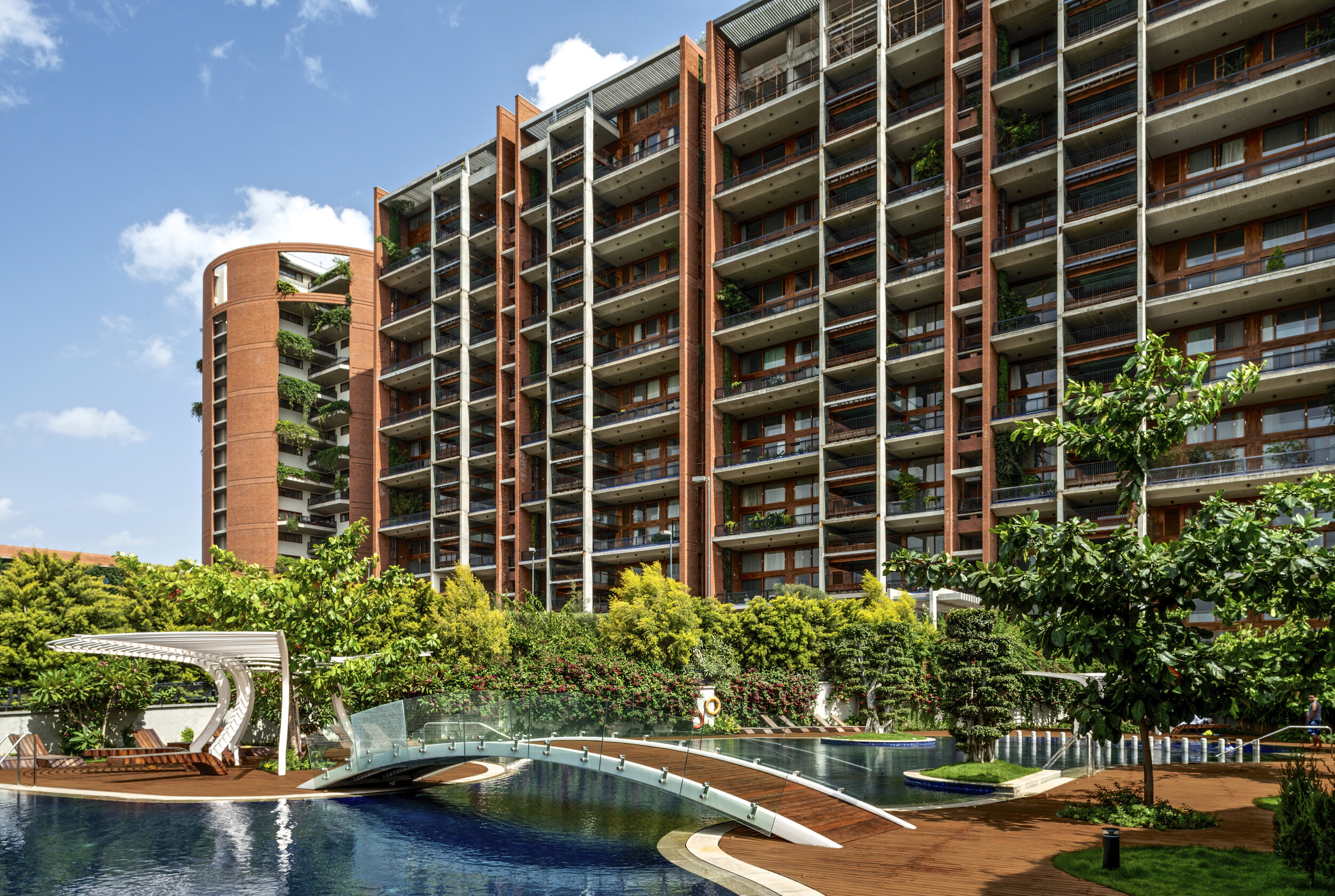 Total Environment's residential tower with lush landscaping and infinity pool