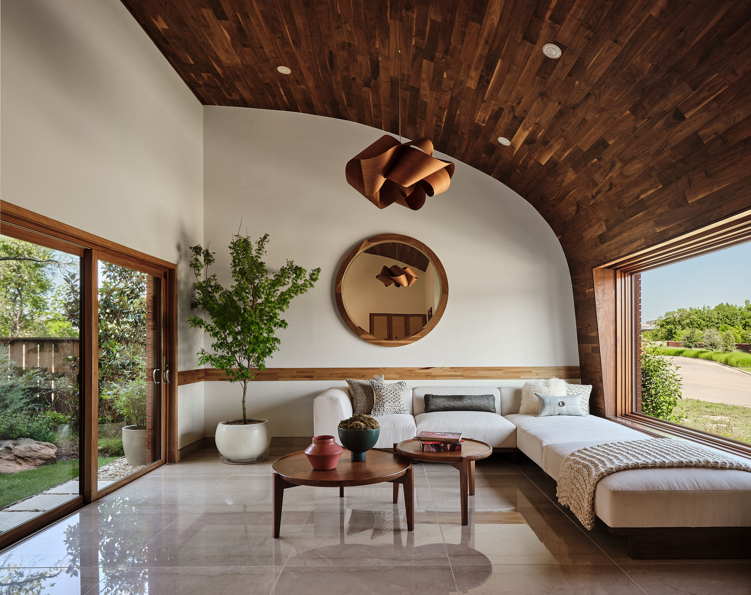 Living room with curved ceiling and garden views